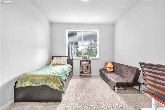 carpeted bedroom featuring baseboards