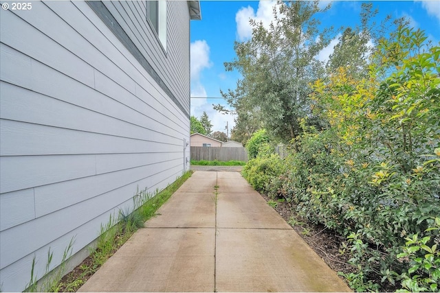 view of side of home featuring a patio area and fence