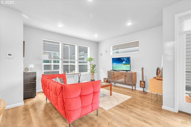 living room with wood finished floors, baseboards, and recessed lighting
