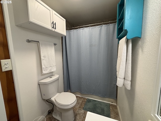 full bath with curtained shower, tile patterned flooring, and toilet