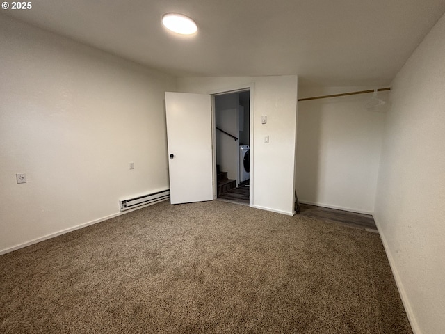 unfurnished bedroom featuring a baseboard heating unit, carpet, a closet, and baseboards