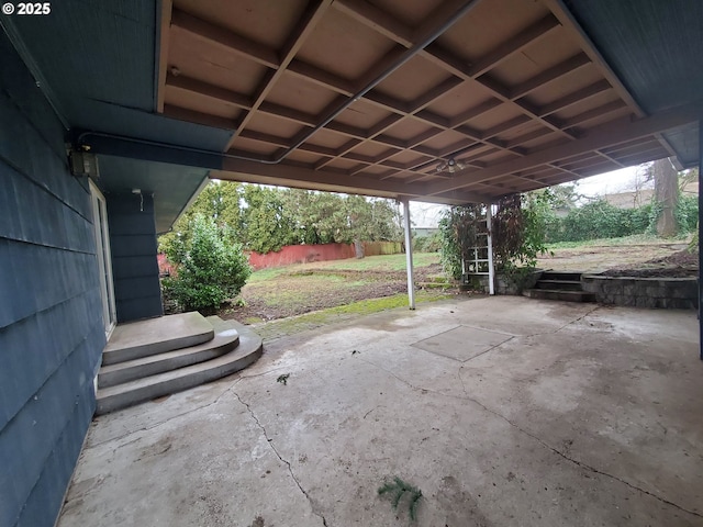 view of patio with a carport and fence