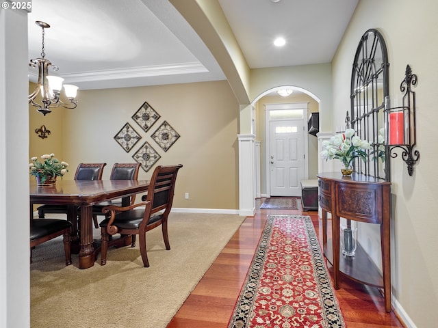 foyer with hardwood / wood-style flooring and a notable chandelier