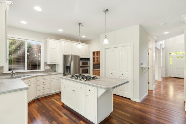 16273 Barlow Dr, Oregon City, OR 97045 - kitchen with appliances with stainless steel finishes, backsplash, dark wood-style floors, light countertops, and recessed lighting