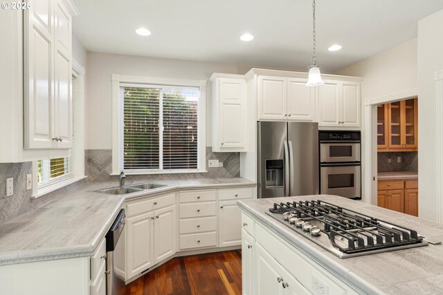 16273 Barlow Dr, Oregon City, OR 97045 - kitchen featuring stainless steel appliances, tasteful backsplash, light countertops, dark wood finished floors, and white cabinets