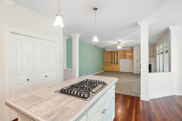 16273 Barlow Dr, Oregon City, OR 97045 - kitchen featuring decorative columns, stainless steel gas stovetop, ceiling fan, dark wood-type flooring, and pendant lighting