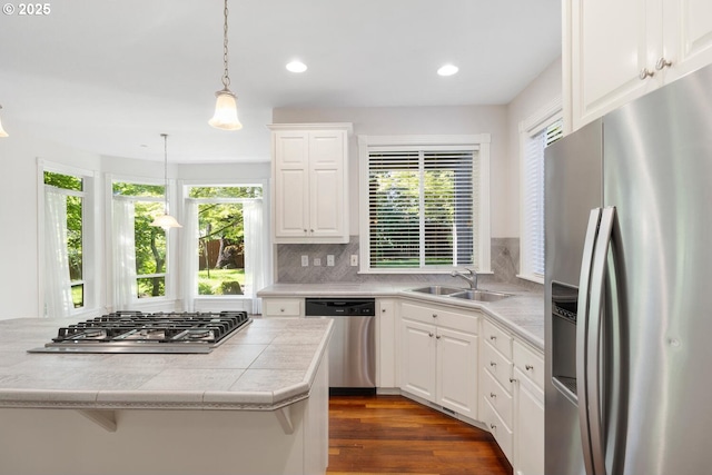 16273 Barlow Dr, Oregon City, OR 97045 - kitchen with stainless steel appliances, plenty of natural light, decorative backsplash, white cabinetry, and recessed lighting