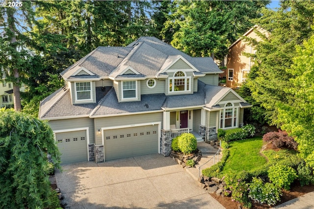 16273 Barlow Dr, Oregon City, OR 97045 - view of front facade featuring driveway, an attached garage, and stone siding