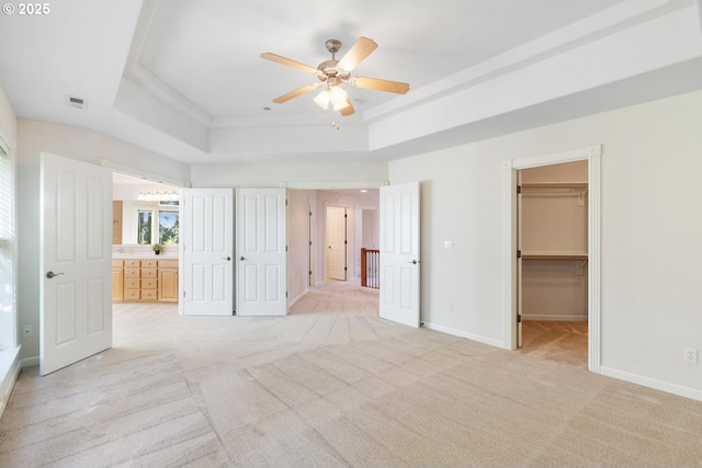 16273 Barlow Dr, Oregon City, OR 97045 - unfurnished bedroom featuring a raised ceiling, light colored carpet, a spacious closet, connected bathroom, and a ceiling fan