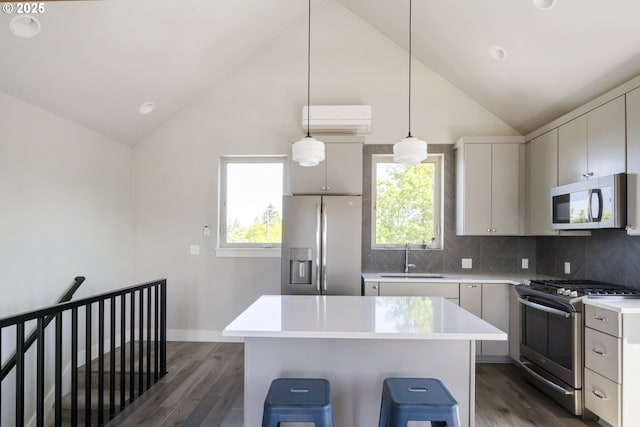 4984 NE 32nd Pl, Portland, OR 97211 - kitchen with stainless steel appliances, a sink, lofted ceiling, dark wood-style flooring, and light countertops