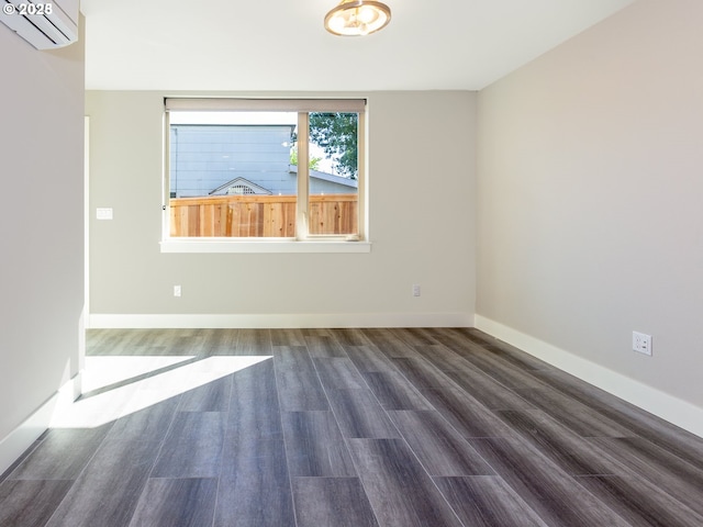 4984 NE 32nd Pl, Portland, OR 97211 - spare room with wood finished floors, a wall mounted air conditioner, and baseboards