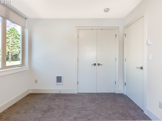 4984 NE 32nd Pl, Portland, OR 97211 - unfurnished bedroom featuring carpet floors, a closet, heating unit, and baseboards