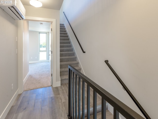 4984 NE 32nd Pl, Portland, OR 97211 - stairway with a wall mounted AC, wood finished floors, and baseboards