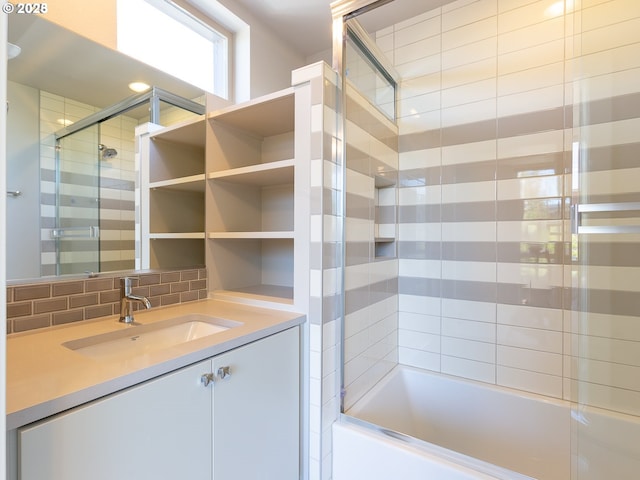 4984 NE 32nd Pl, Portland, OR 97211 - bathroom featuring combined bath / shower with glass door, vanity, and tasteful backsplash