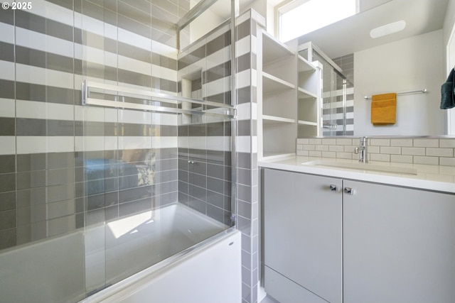 4984 NE 32nd Pl, Portland, OR 97211 - bathroom with combined bath / shower with glass door, vanity, and tasteful backsplash