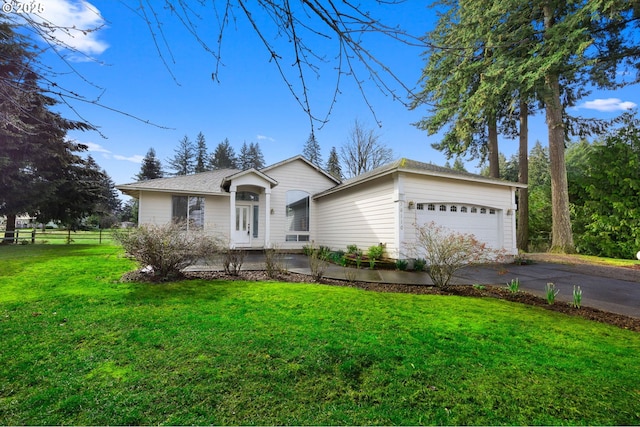 single story home with a front yard, driveway, an attached garage, and fence