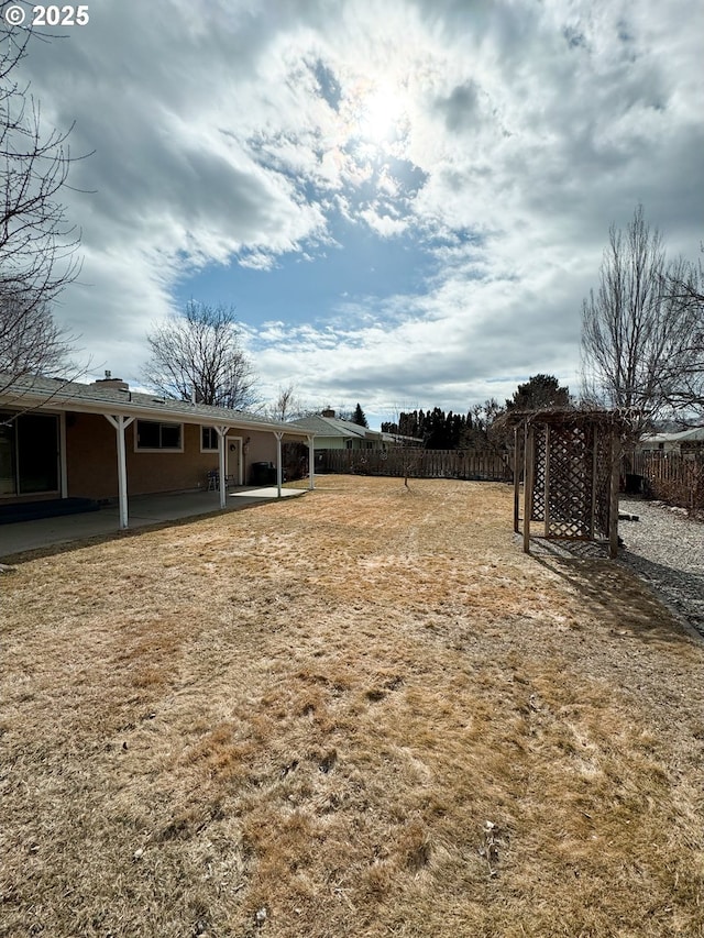 view of yard featuring a patio and fence