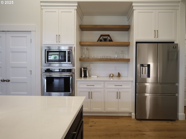 1703 SE 42nd Way, Brush Prairie, WA 98606 - kitchen featuring appliances with stainless steel finishes, light countertops, backsplash, and light wood-type flooring