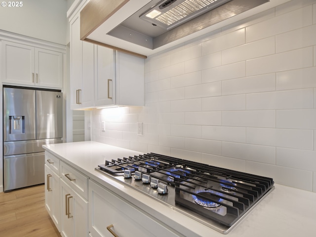 1703 SE 42nd Way, Brush Prairie, WA 98606 - kitchen with appliances with stainless steel finishes, white cabinetry, light countertops, and tasteful backsplash