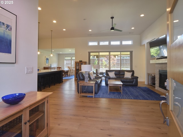 1703 SE 42nd Way, Brush Prairie, WA 98606 - living room featuring a glass covered fireplace, a ceiling fan, recessed lighting, healthy amount of natural light, and light wood-style floors
