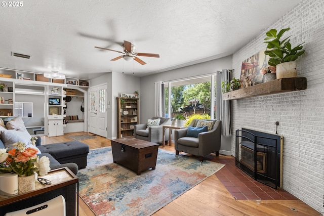 2408 N College St, Newberg, OR 97132 - living room featuring a ceiling fan, wood finished floors, and brick wall