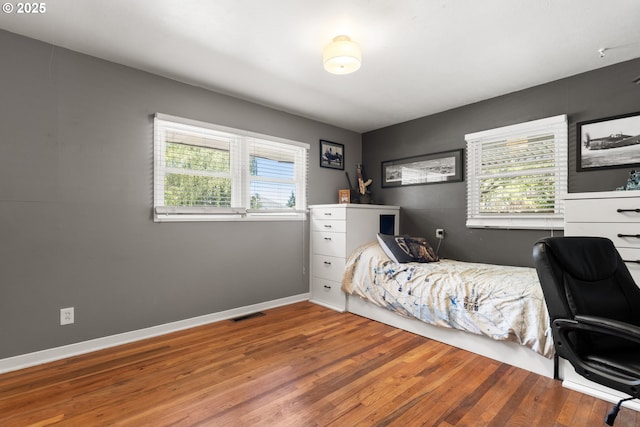 2408 N College St, Newberg, OR 97132 - bedroom featuring multiple windows, wood finished floors, an office area, and baseboards