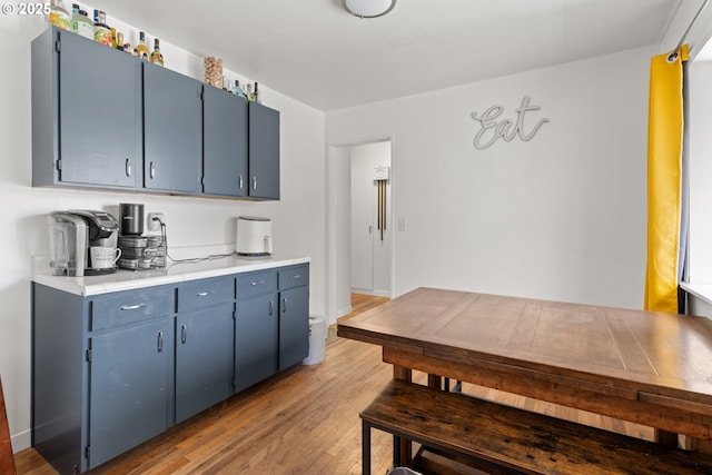 2408 N College St, Newberg, OR 97132 - kitchen featuring blue cabinetry, light wood-style floors, and light countertops