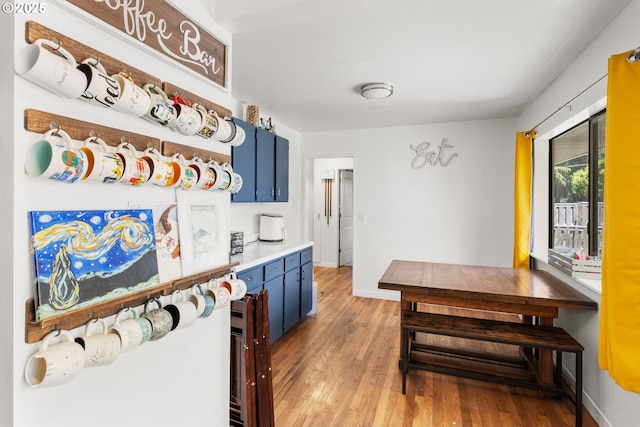 2408 N College St, Newberg, OR 97132 - kitchen with blue cabinets, light wood-style floors, baseboards, and light countertops