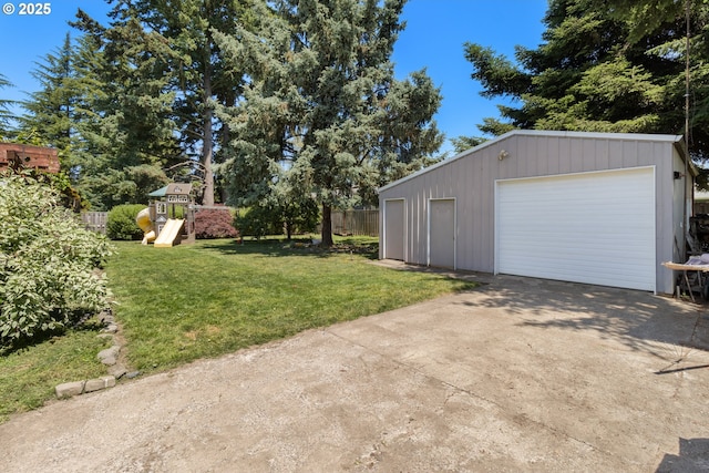 2408 N College St, Newberg, OR 97132 - view of yard featuring a garage, driveway, an outdoor structure, and a playground