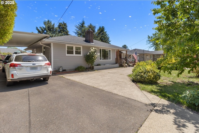 2408 N College St, Newberg, OR 97132 - view of front of home featuring an attached carport, a chimney, and asphalt driveway