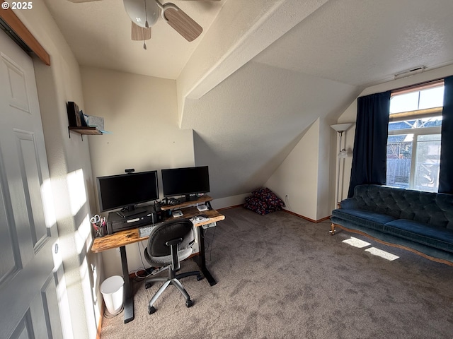 carpeted home office featuring vaulted ceiling and ceiling fan