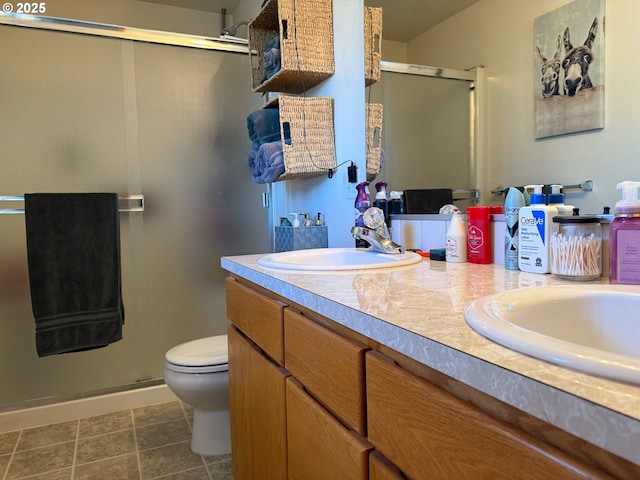 bathroom featuring an enclosed shower, vanity, and toilet