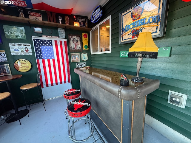 bar featuring concrete flooring