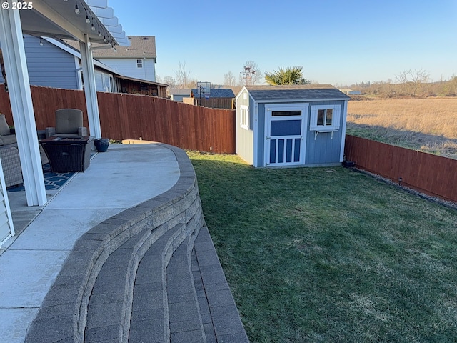 view of yard featuring a storage shed and a patio