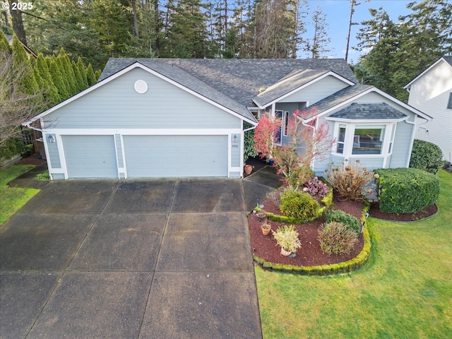 view of front of property featuring a garage and a front yard