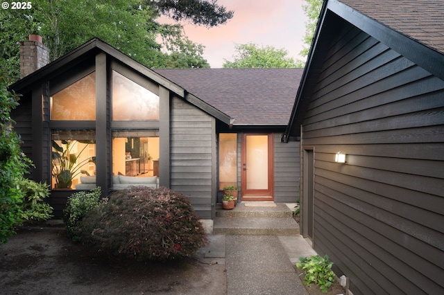 511 SW Colony Dr, Portland, OR 97219 - doorway to property featuring a shingled roof and a chimney