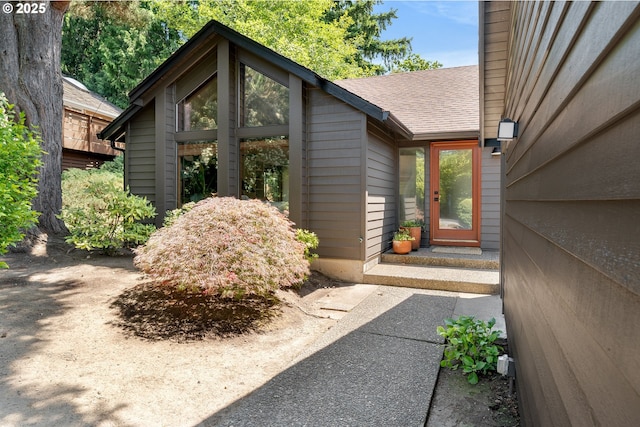 511 SW Colony Dr, Portland, OR 97219 - view of exterior entry with roof with shingles and a chimney