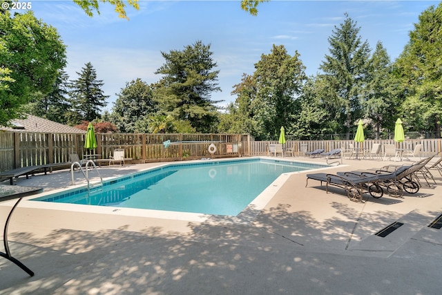 511 SW Colony Dr, Portland, OR 97219 - community pool with a patio and view of wooded area