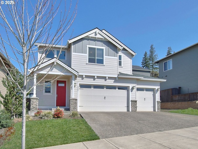5807 N 89th Ave, Camas, WA 98607 - craftsman-style home with board and batten siding, an attached garage, stone siding, and driveway