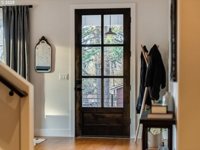 doorway to outside with light wood-type flooring