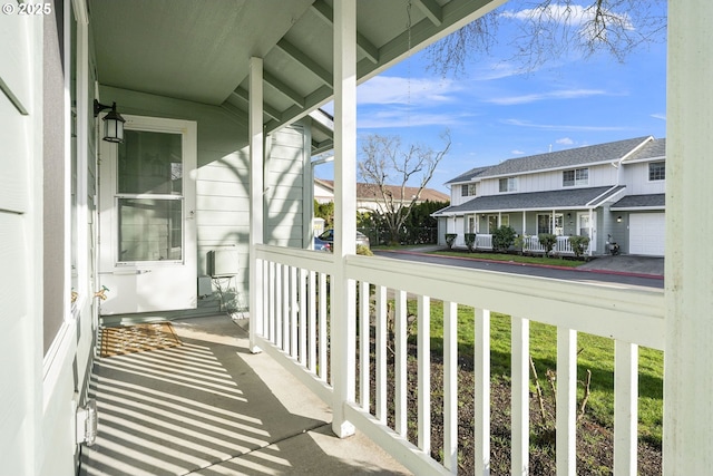 balcony featuring a residential view and covered porch