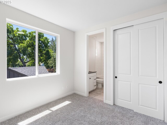 7244 SE 78th Ave Unit 2, Portland, OR 97206 - unfurnished bedroom with light colored carpet, ensuite bath, and a closet
