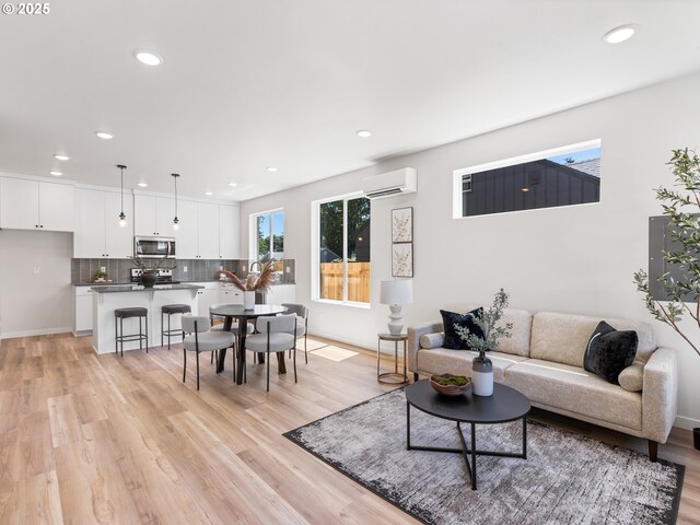 7244 SE 78th Ave Unit 2, Portland, OR 97206 - living room featuring a wall mounted air conditioner and light hardwood / wood-style floors
