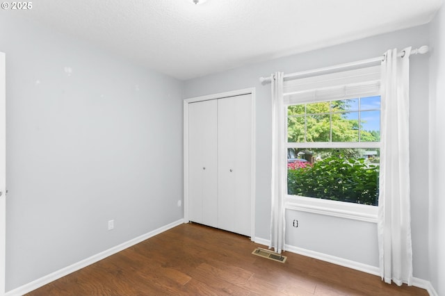 21689 SW Klickitat Ct, Tualatin, OR 97062 - unfurnished bedroom with wood finished floors, baseboards, and a closet