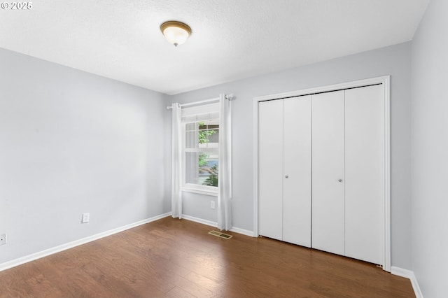 21689 SW Klickitat Ct, Tualatin, OR 97062 - unfurnished bedroom with wood finished floors, baseboards, and a closet