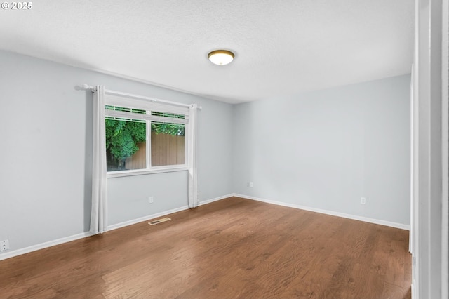 21689 SW Klickitat Ct, Tualatin, OR 97062 - empty room featuring wood finished floors and baseboards