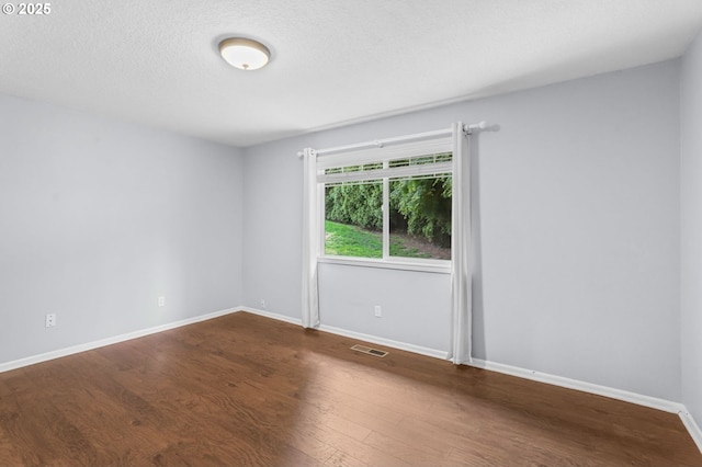 21689 SW Klickitat Ct, Tualatin, OR 97062 - unfurnished room with wood finished floors, baseboards, and a textured ceiling