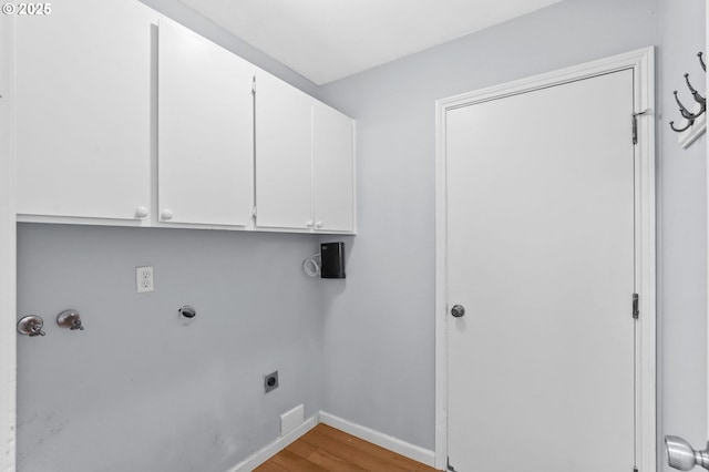 21689 SW Klickitat Ct, Tualatin, OR 97062 - washroom featuring electric dryer hookup, cabinet space, light wood-style floors, baseboards, and hookup for a washing machine