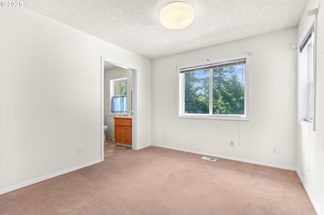 18183 SE Richey Rd, Gresham, OR 97080 - unfurnished bedroom featuring light carpet, a textured ceiling, and ensuite bath