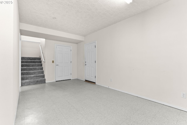 18183 SE Richey Rd, Gresham, OR 97080 - empty room featuring tile patterned floors, stairs, and a textured ceiling